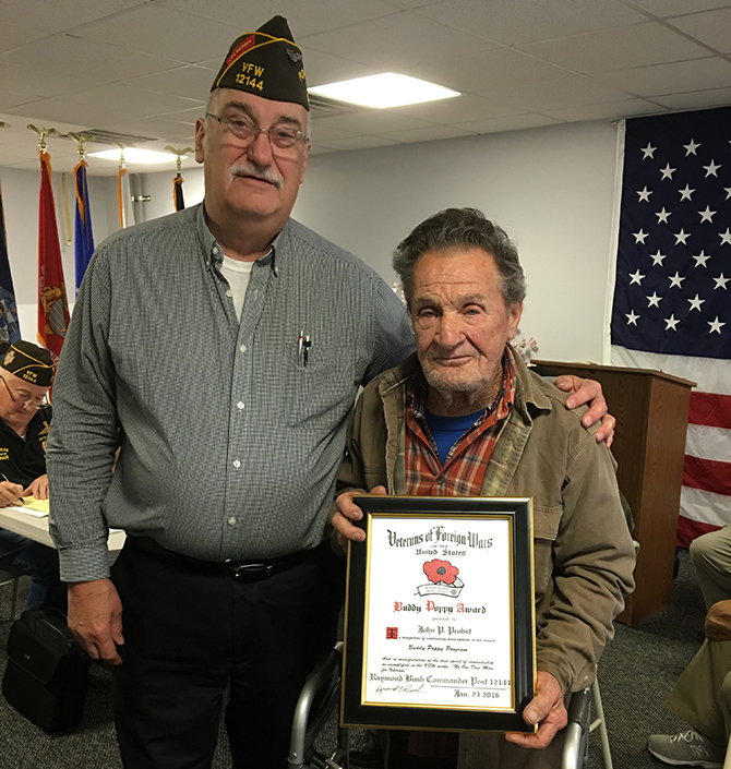 VFW Post #12144 Post Commander Raymond Bush presents the award to John Probst