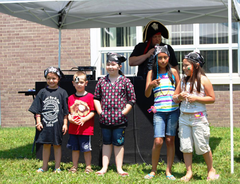 DJ Robert Gerardi (back) with some of the winners of the pirate costume contest. DJ Robert Gerardi (back) with some of the winners of the pirate costume contest.
