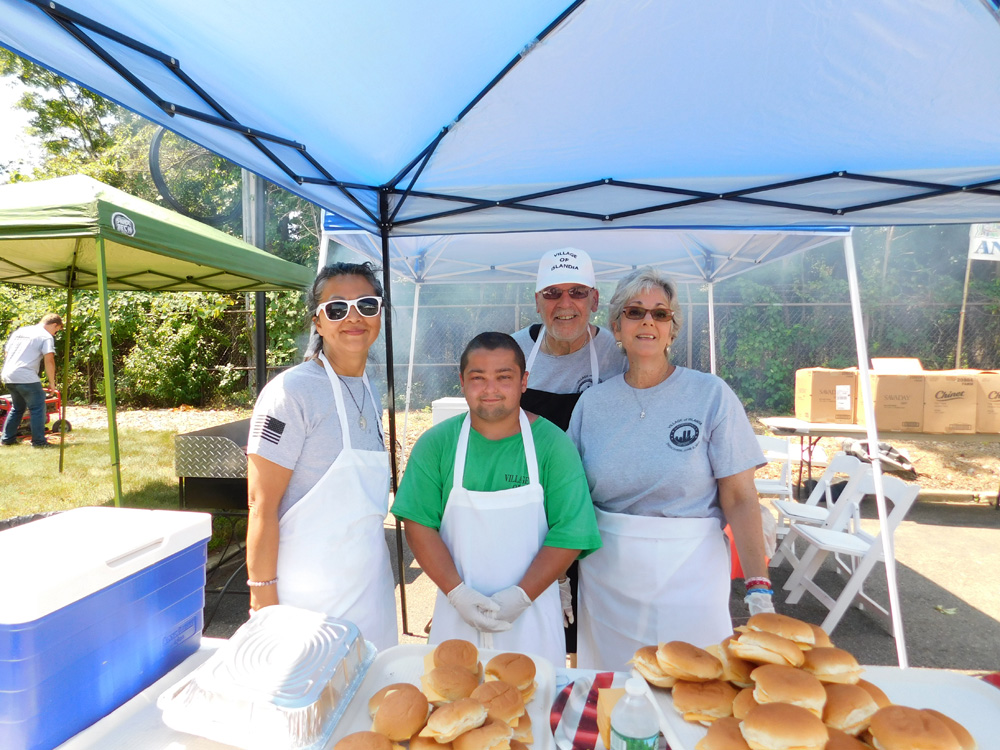 Village volunteers (left to right) Gina Lekstutis, Thomas Lynster, Tommy Annicaro and Rosanne Freda helped out at the Village of Islandia’s 13th Annual Bar-B-Que.