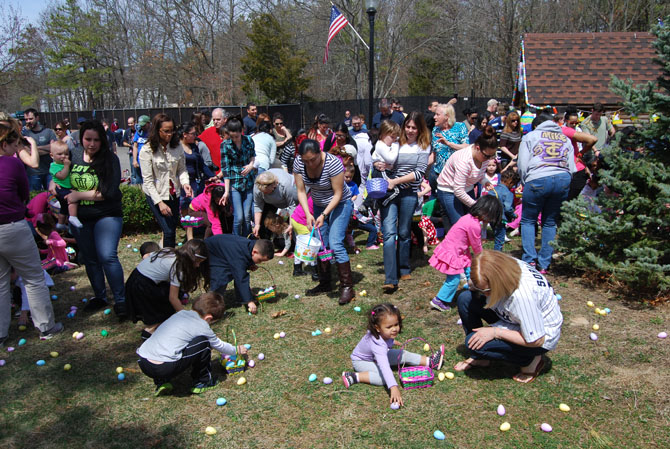 Parents watch their children collect Easter eggs at the Village of Islandia's 9th annual Easter Egg Hunt on April 12.