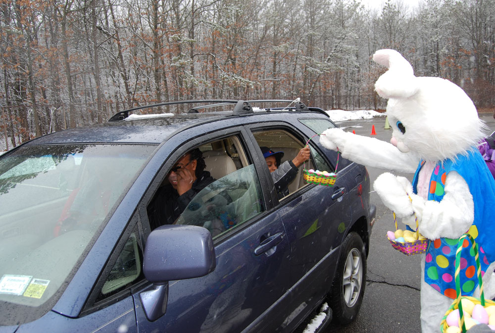 The Easter Bunny hands out a basket full of eggs to a child at the Village of Islandia’s drive-through Easter event on March 28.