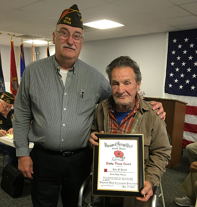 VFW Post #12144 Post Commander Raymond Bush (left) presents the award to John Probst (right).