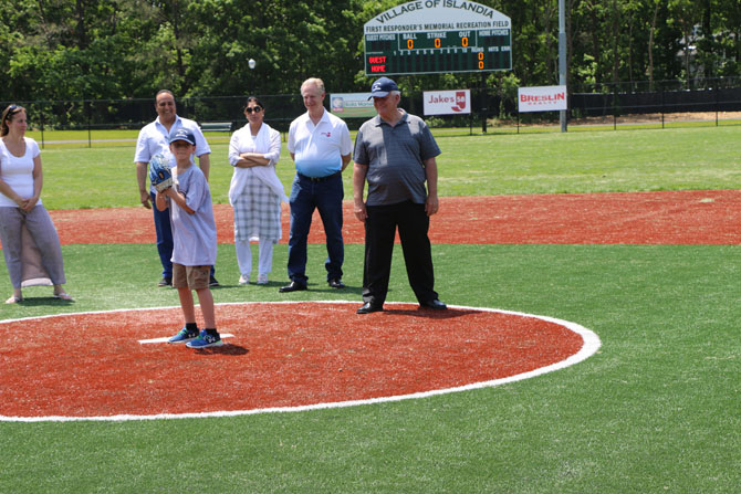 Allan M. Dorman (right), Mayor, Village of Islandia, watches Collin throw out the first pitch to commemorate the grand opening of the First Responders Recreational Ball Field on June 2. Also pictured (left to right): Denise Schrage, Commissioner of Parks and Recreation, Village of Islandia; Harry Singh, Chief Executive Officer, Bolla Market; Kamljit Singh; and Chuck Kilroy, Suffolk President and General Manager, Jake’s 58.