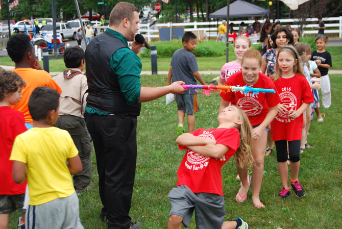 Children take part in a limbo contest during the Village of Islandia’s annual Bar-B-Que on July 9.