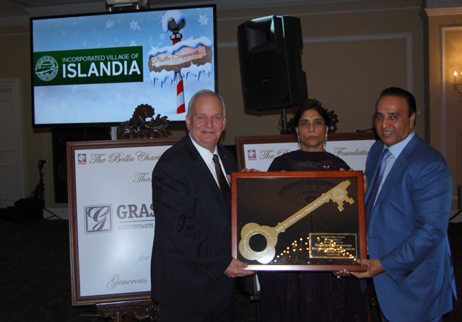 Mayor Allan M. Dorman (left) accepts an award from Kamljit Singh (center) and Harry Singh (right) of the Bolla Charity Foundation during the organization’s Second Annual Gala at Oheka Castle on December 7.