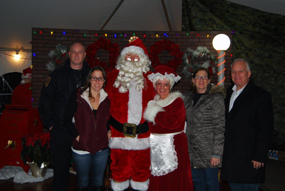 Santa Claus (third from left) joins Islandia Village officials at the village’s Christmas tree lighting ceremony at Village Hall on December 1. Also pictured (left to right): Michael Zaleski, Deputy Mayor; Denise Schrage, Commissioner, Parks and Recreation; Barbara Lacey, Trustee, as “Mrs. Claus”; Patty Peters, Trustee; and Allan M. Dorman, Mayor, Village of Islandia.
