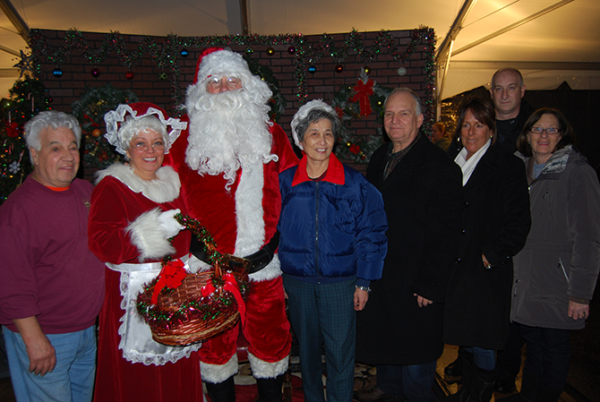 Islandia Village Mayor Allan M. Dorman (fourth from right) is joined by Santa Claus and village officials at the 9th annual Christmas tree lighting ceremony on December 6. Also pictured (l-r): Tony Church, Village Administrator; Barbara Lacey, Trustee, as "Mrs. Claus"; Shy Main Shieh, Event Volunteer and Islandia resident; Diane Olk, Deputy Mayor; and Mike Zaleski and Patty Peters, Trustees.