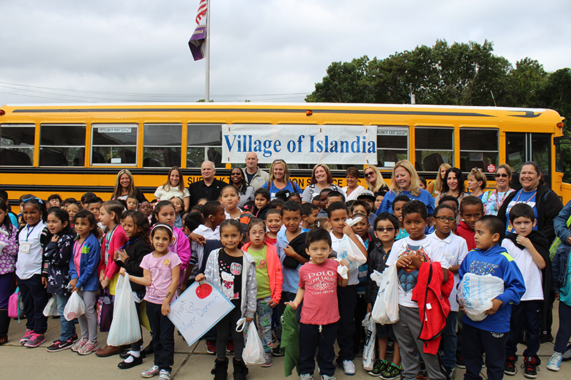 Pictured with the students and teachers at Andrew T. Morrow Elementary School are Denise Schrage (back row, second from left), Activities Director, Village of Islandia, and Mayor Allan M. Dorman (back row, third from left); Dr. Neema Coker (back row, fourth from left), Principal, Andrew T. Morrow Elementary School; and Michael Zaleski (back row, center), Deputy Mayor, before the children leave for their field trip on September 28.