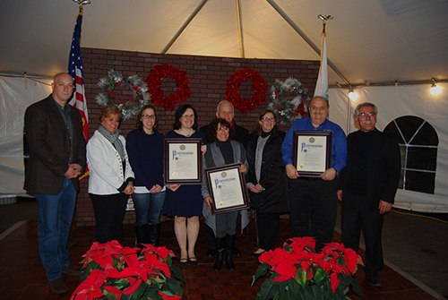 Patricia Ann Kellner (fourth from left), President, The DNA Genealogy Group, Marie Depaula-Walsh (fourth from right) and Robert Sutton (third from right), Volunteer Firefighter, Central Islip Fire Department, were recognized at a Good Neighbor Gala that was held on the grounds of Village Hall on November 30. Also pictured (left to right): Michael Zaleski, Deputy Mayor; Barbara Lacey, Trustee; Denise Schrage, Commissioner, Parks and Recreation; Patty Peters and Burhan Kisla, Trustees, Village of Islandia. Standing behind Ms. Walsh: Allan M. Dorman, Mayor, Village of Islandia.