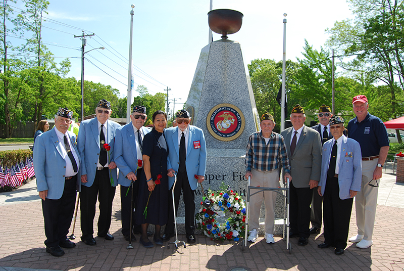 Allan M. Dorman (fourth from right), Mayor, Village of Islandia, is joined by members of the Central Long Island chapter of the Korean War Veterans Association and the Col. Francis S. Midura Veterans of Foreign Wars Post #12144, Gina Lekstutis (fourth from left), Owner, Gina’s Enchanted Flower Shoppe, and Michael Fitzpatrick (right), New York State Assemblyman, at the village’s Memorial Day ceremony on May 25.