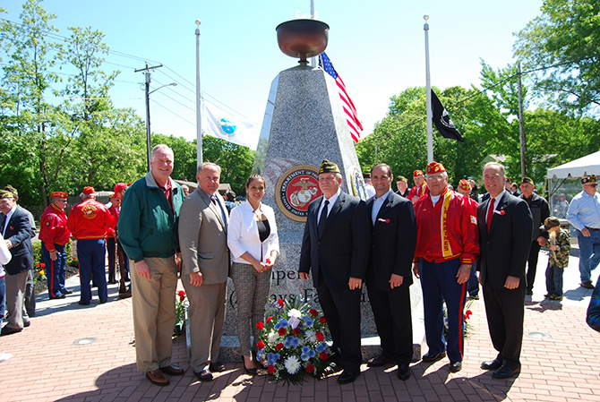 Allan M. Dorman (center), Mayor, Village of Islandia, is joined by (left to right) Michael Fitzpatrick, New York State Assemblyman; John Cochrane, Jr., Councilman, Town of Islip; Monica Martinez, Suffolk County Legislator; Leo Maese, Commandant, Suffolk County Detachment #247 Marine Corps League; and Tom Cilmi, Suffolk County Legislator in front of the Veteran's Memorial Triangle at the village's Memorial Day ceremony on May 23.