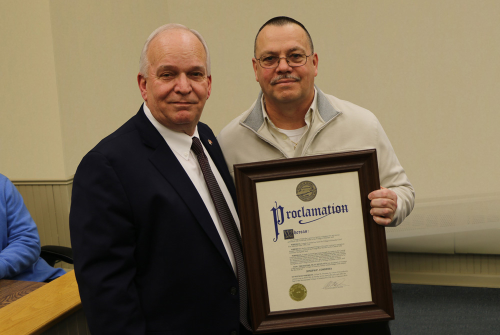 Mayor Allan M. Dorman (left), presents a proclamation to Joe Correira (right) for having served for nearly 25 years as Village Fire Marshal during a special ceremony at Village Hall on January 29.