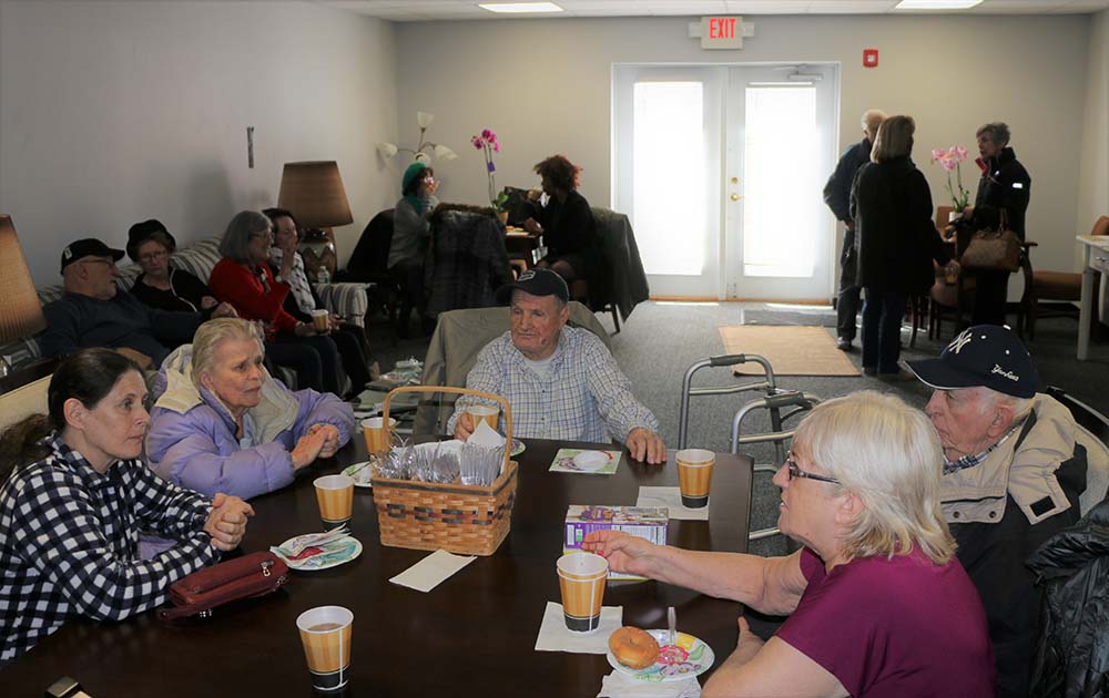 Residents enjoy refreshments and conversation during the grand opening of the Islandia Senior Center on March 23.