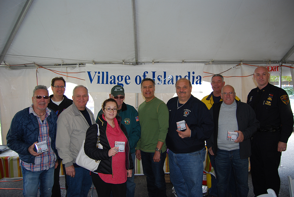 Allan M. Dorman (third from left), Mayor, Village of Islandia, is joined by Village residents who received free smoke detectors as part of the Village’s commemoration of National Fire Prevention Month during the Pancake Breakfast with the Mayor on October 29. Also pictured are Jesse Walia (fifth from right), Owner, Dunkin’ Donuts of Islandia; Robert Sutton (fourth from right), Fire Prevention Officer, Central Islip Fire Department; Kevin McCarroll (third from right), Safety Officer, Central Islip Fire Department; and Michael Zaleski (right), Fire Marshal, Village of Islandia.