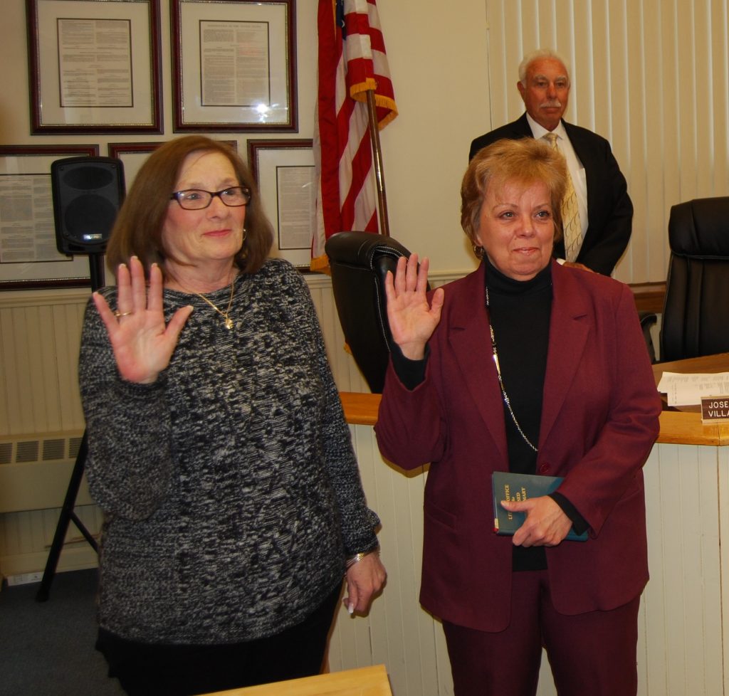 Village Trustees Patty Peters (left) and Barbara Lacey (right) are sworn in during a special ceremony on April 2 at Village Hall. Also pictured is Village Justice Alan Wolinsky (standing).