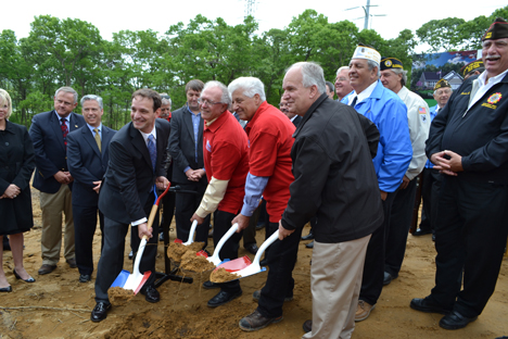 Mayor Allan M. Dorman (right) breaks ground with a ceremonial shovel at the proposed Veterans Way subdivision on May 23. He is joined by (left to right): Adam Famularo, General Manager, Cloud Computing Business, CA Technologies; Edgar Goodale, Chairman, and Tom Datre, President, Long Island Home Builders Care Development Corp.