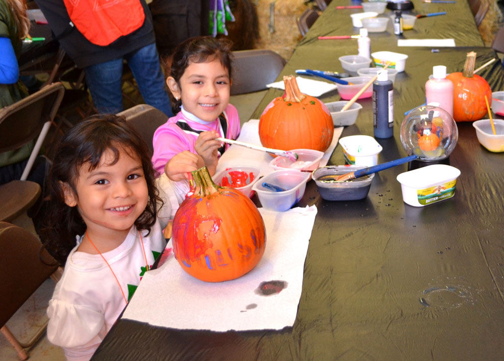 The children of Islandia Village join their parents in decorating their pumpkins at the Village of Islandia’s 7th Annual Pumpkin Fest.