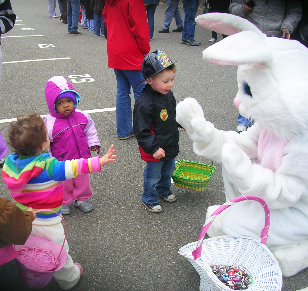 The Easter bunny meets with some of the children at Islandia Village’s fourth annual Easter Egg Hunt on April 4.