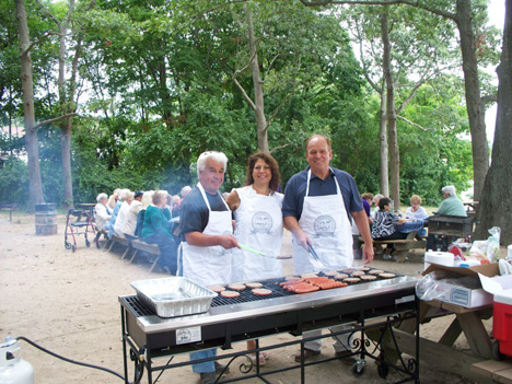 Islandia Village Staff Serves BBQ Lunch for Arbors Assisted Living Residents