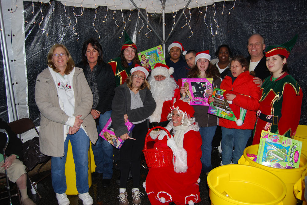 Allan M. Dorman (second from right), Mayor, Islandia Village, joins Santa Claus and participants at the 4th annual Christmas tree lighting.