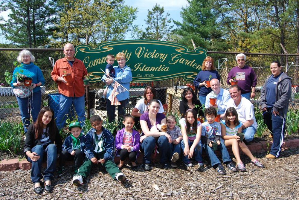 Islandia Village Mayor Allan Dorman (standing, second from left) joins village trustees and local residents in the sixth annual Community Garden Planting on May 7.