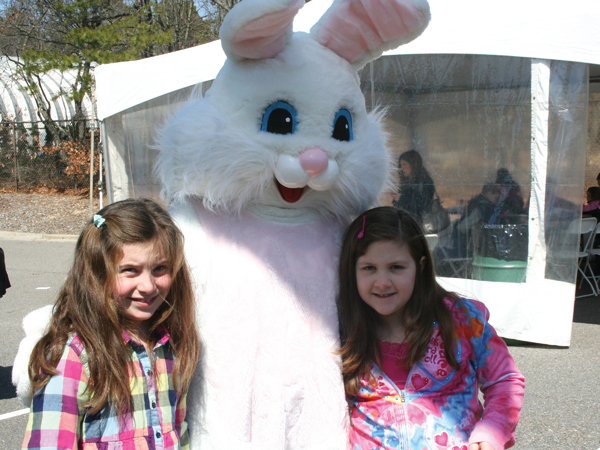 Two children pose with the Easter Bunny at the 5th Annual Easter Egg Hunt at Islandia Village Hall on March 27.