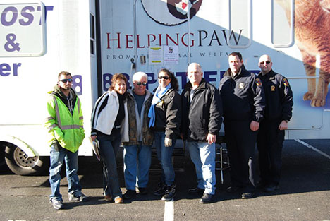 Pictured (left to right): John Haufe, Employee, Islandia Village Highway Department; Josephine Palladino, Village Resident; Tony Church, Islandia Village Administrator; Michele Alier, Coordinator, Helping Paw; Mayor Allan M. Dorman, Village of Islandia; and Philip Falco and Mike Allen, Islandia Village Public Safety Officers.