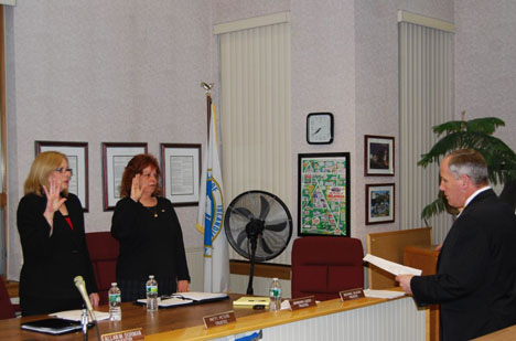 Islandia Village Attorney Joseph Prokop (right) swears in Village Trustees Patricia Peters (left) and Barbara Lacey (center) at the April 5 Village Board meeting.