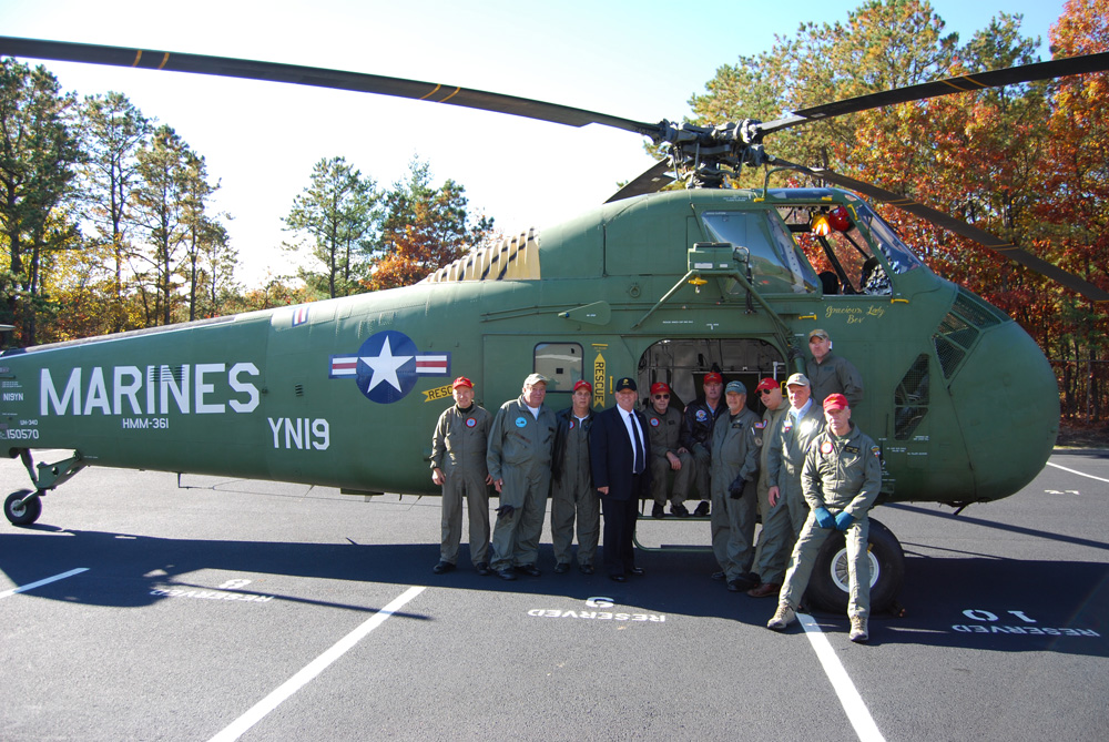 Islandia Village Mayor Allan Dorman (fourth from left) poses with members of Marine Helicopter Squadron 361 Veterans Association, Inc. in front of a Sikorsky UH-34D helicopter that was part of the village’s Veterans Day ceremony on November 6.Islandia Village Mayor Allan Dorman (fourth from left) poses with members of Marine Helicopter Squadron 361 Veterans Association, Inc. in front of a Sikorsky UH-34D helicopter that was part of the village’s Veterans Day ceremony on November 6.