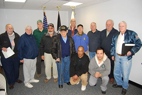 Mayor Allan M. Dorman (back row, third from right) poses with local war veterans inside the Village of Islandia Commons, where the mayor announced plans to establish a Veterans of Foreign Wars post in the village.