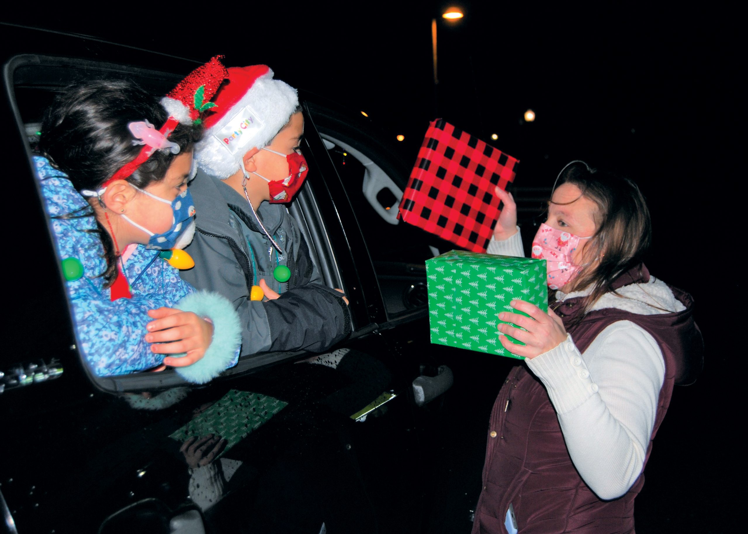 Parks and Recreation Commissioner Denise Schrage hands out gifts to local children.